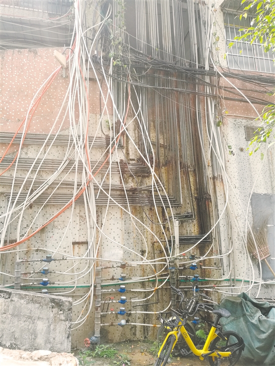 良化西44—46号居民楼楼下错落的自来水管一直延伸到楼上,形成一挂“水管瀑布”。 良化西44—46号居民楼楼下错落的自来水管一直延伸到楼上,形成一挂“水管瀑布”。